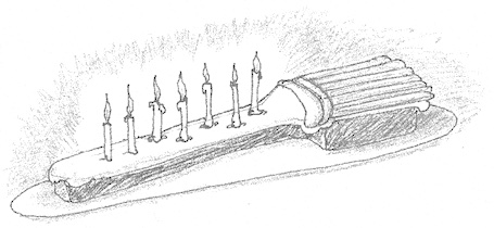 Drawing of a flat, square-edged cake shaped like a broomstick with an uneven row of candles on the handle portion.